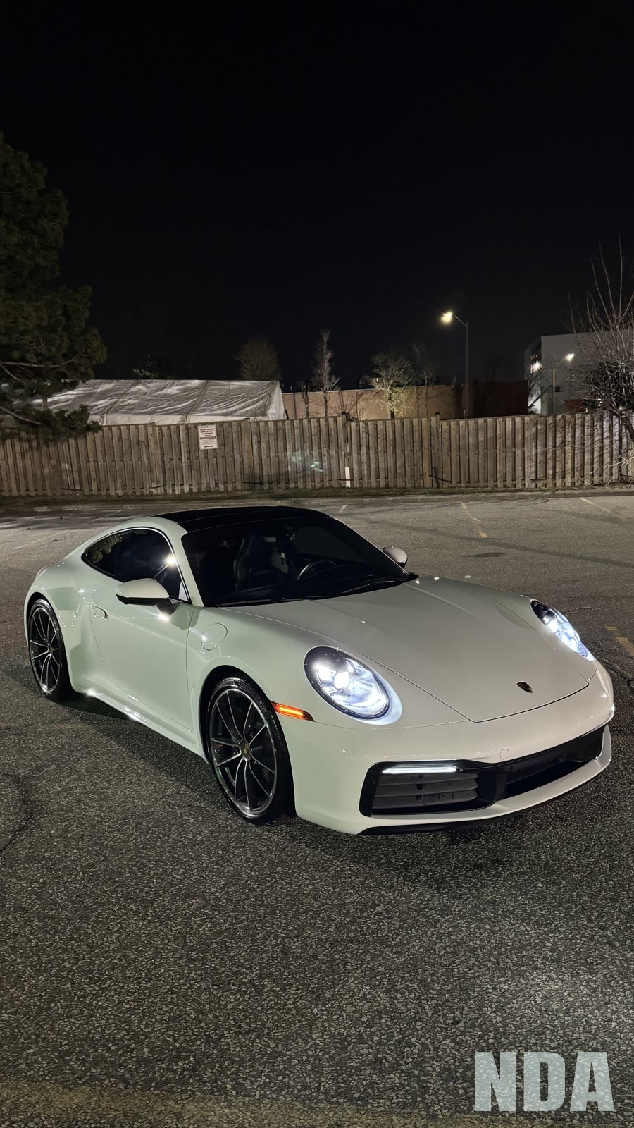 White Porsche 911 Carrera shot at night after detailing