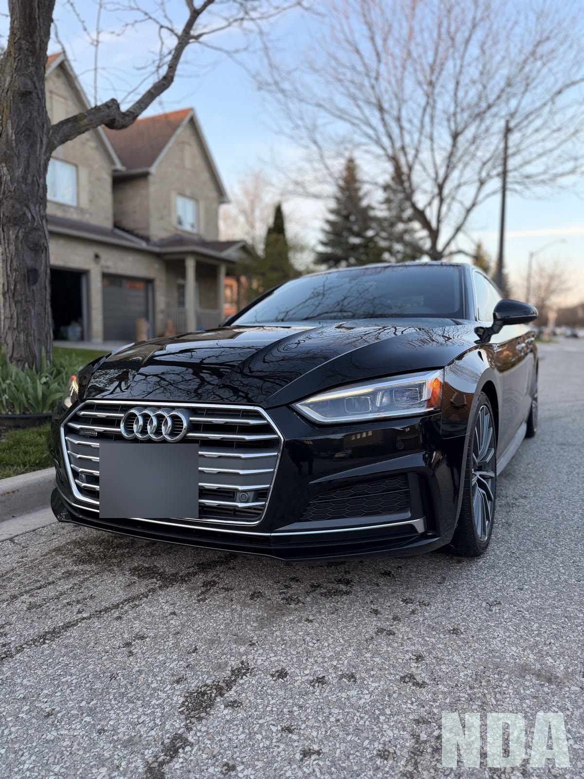 Black Audi A5 Sportback in golden hour light