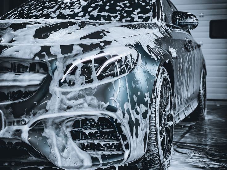 A car buried in foam during the hand wash